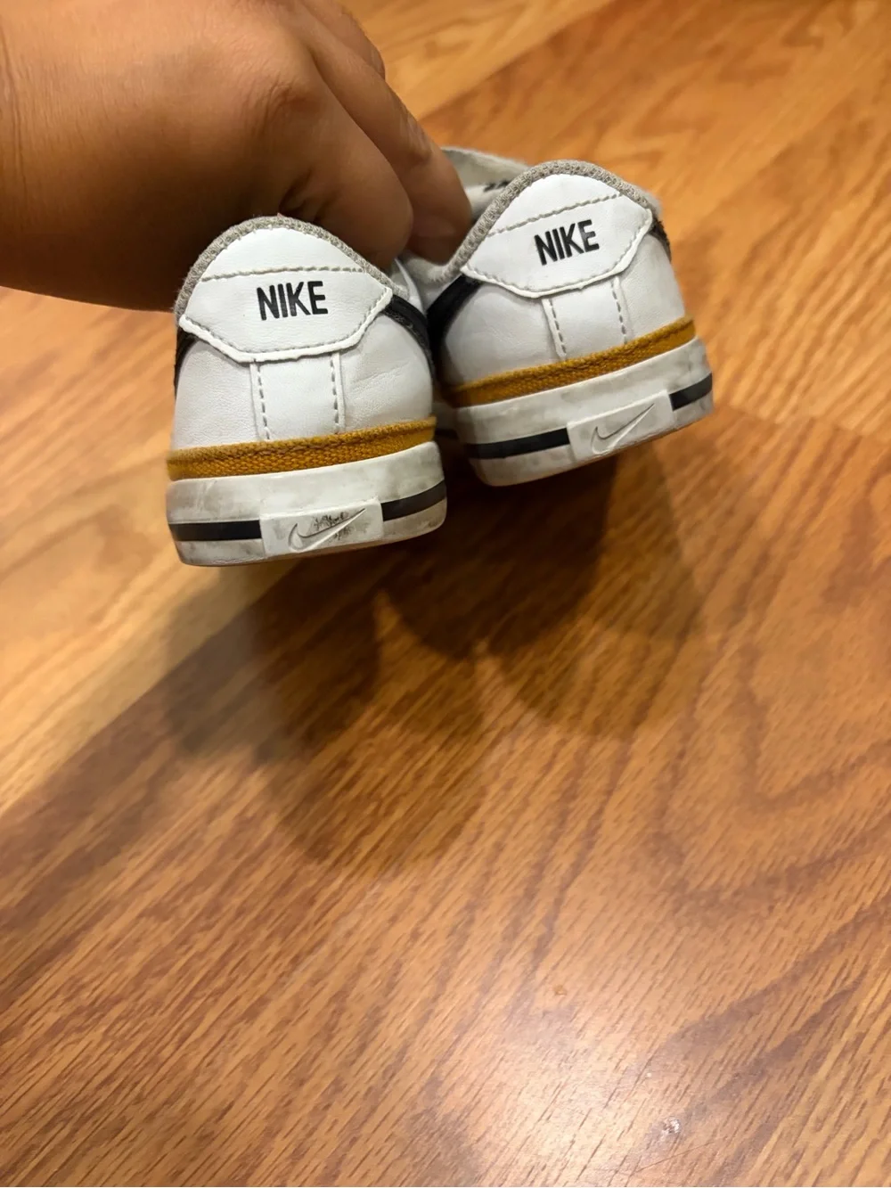 Nike Kids White Sneakers with Black Swoosh and Brown Accent